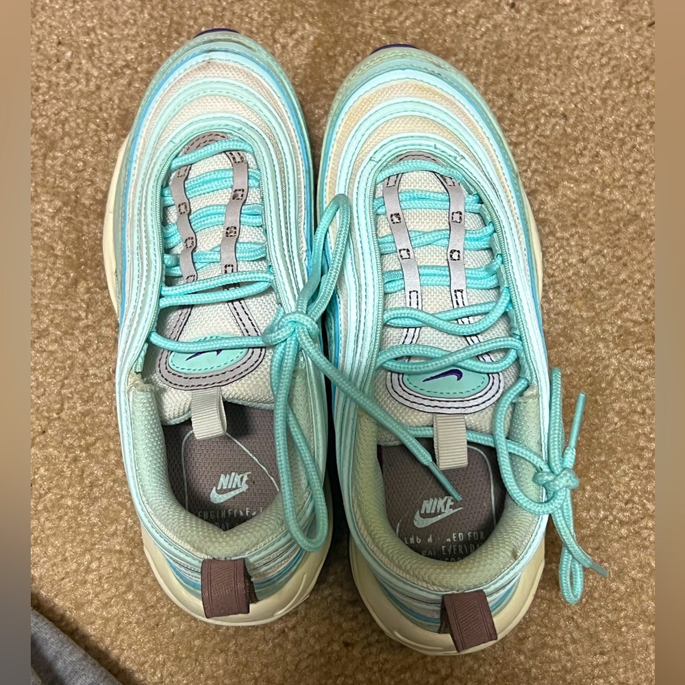 A pair of white and blue nike max 97 size 6
